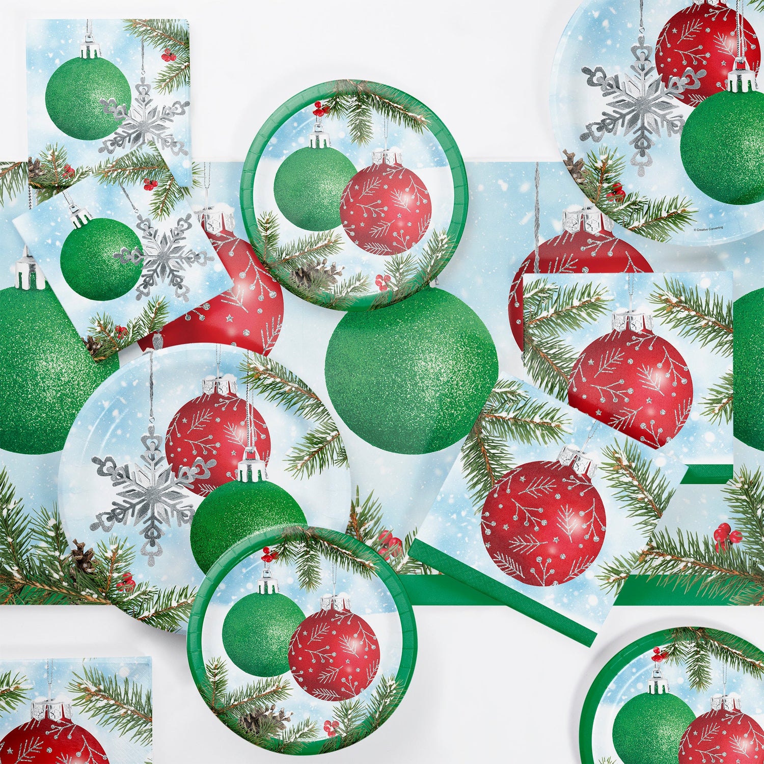 Pattern of Christmas ornaments, snowflakes, and greenery on a blue background.