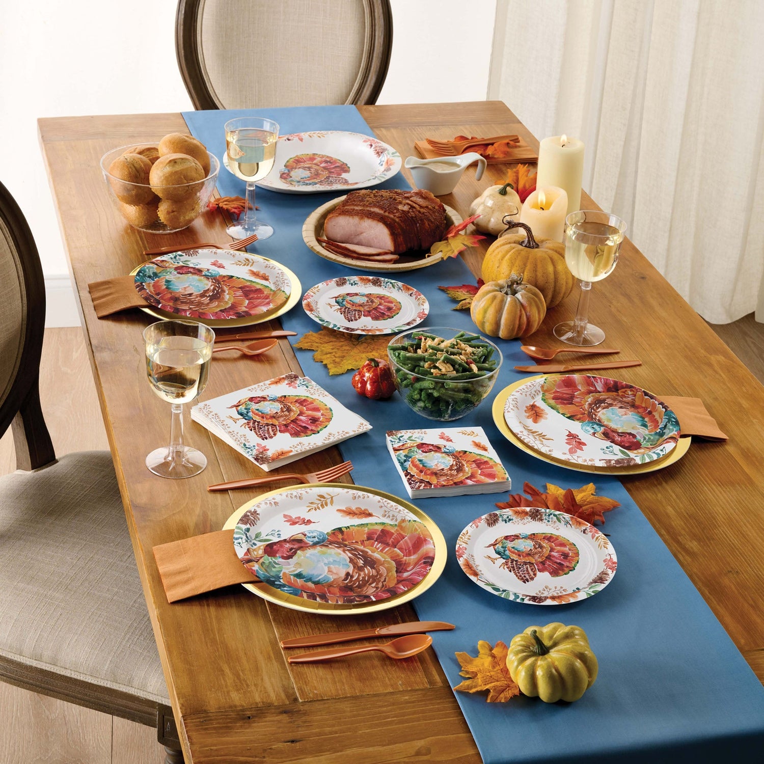 Tasteful Turkey Party Supplies displayed on a wooden table with autumn decorations
