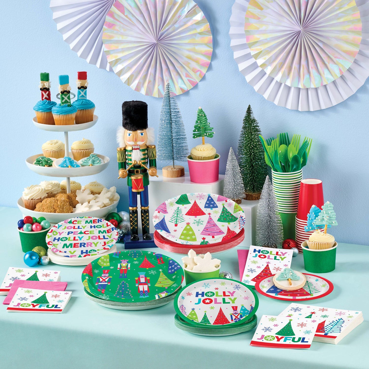 Joyful and Jolly Party Supplies displayed on a table with holiday decorations