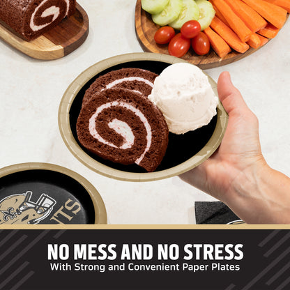 A hand holds a paper plate with a slice of chocolate cake and a scoop of vanilla ice cream, with more plates and food props visible on a tabletop. Text at the bottom reads, 'NO MESS AND NO STRESS With Strong and Convenient Paper Plates.