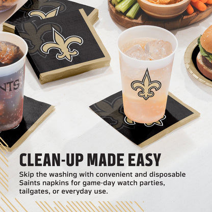 Saints New Orleans themed disposable napkins and matching cups shown on a table with drinks, plus promotional text reading 'CLEAN-UP MADE EASY.'.