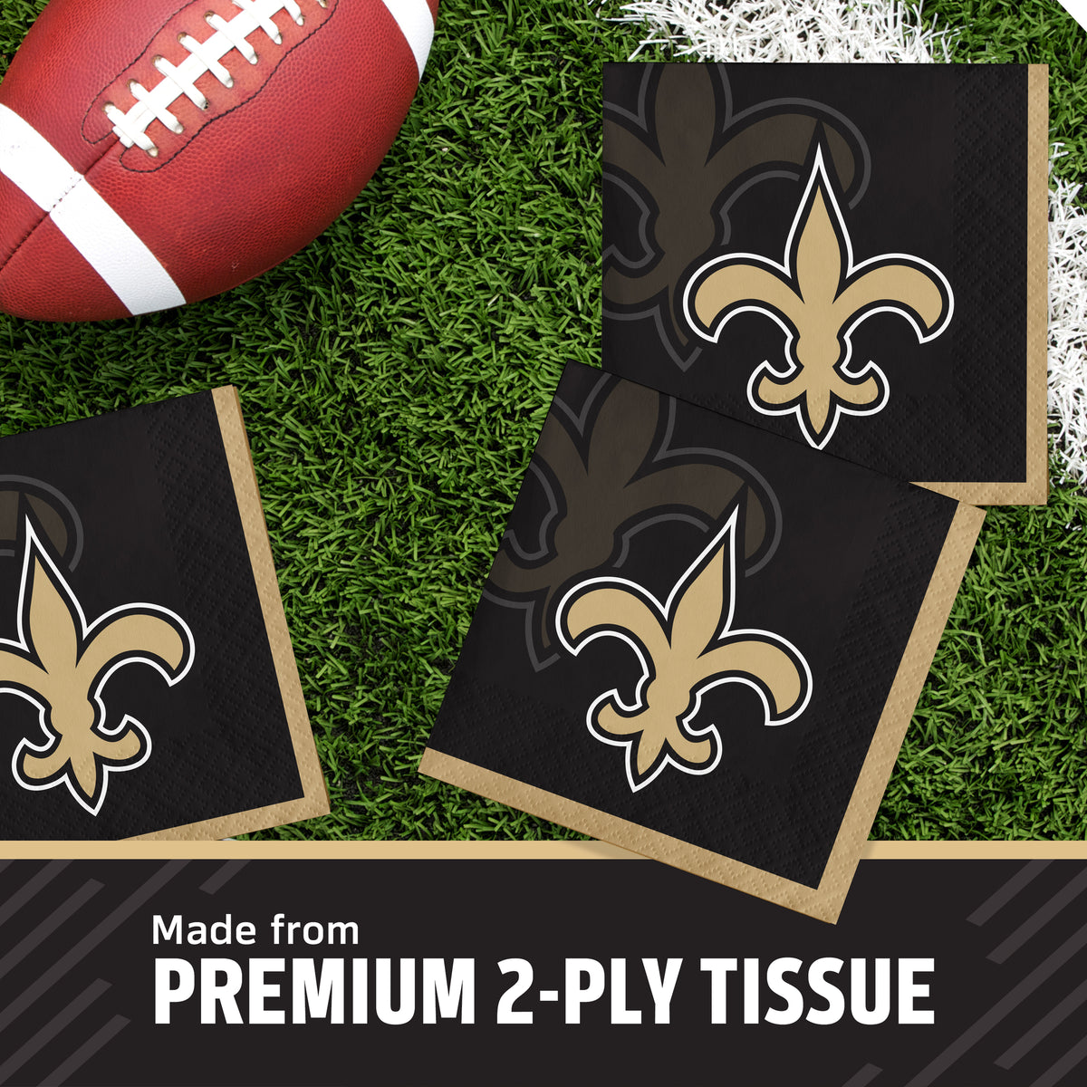 Three square black New Orleans Saints tissue napkins with the team's fleur-de-lis logo, arranged on a green turf-like surface with a football prop and a text banner reading 'Made from PREMIUM 2-PLY TISSUE'.