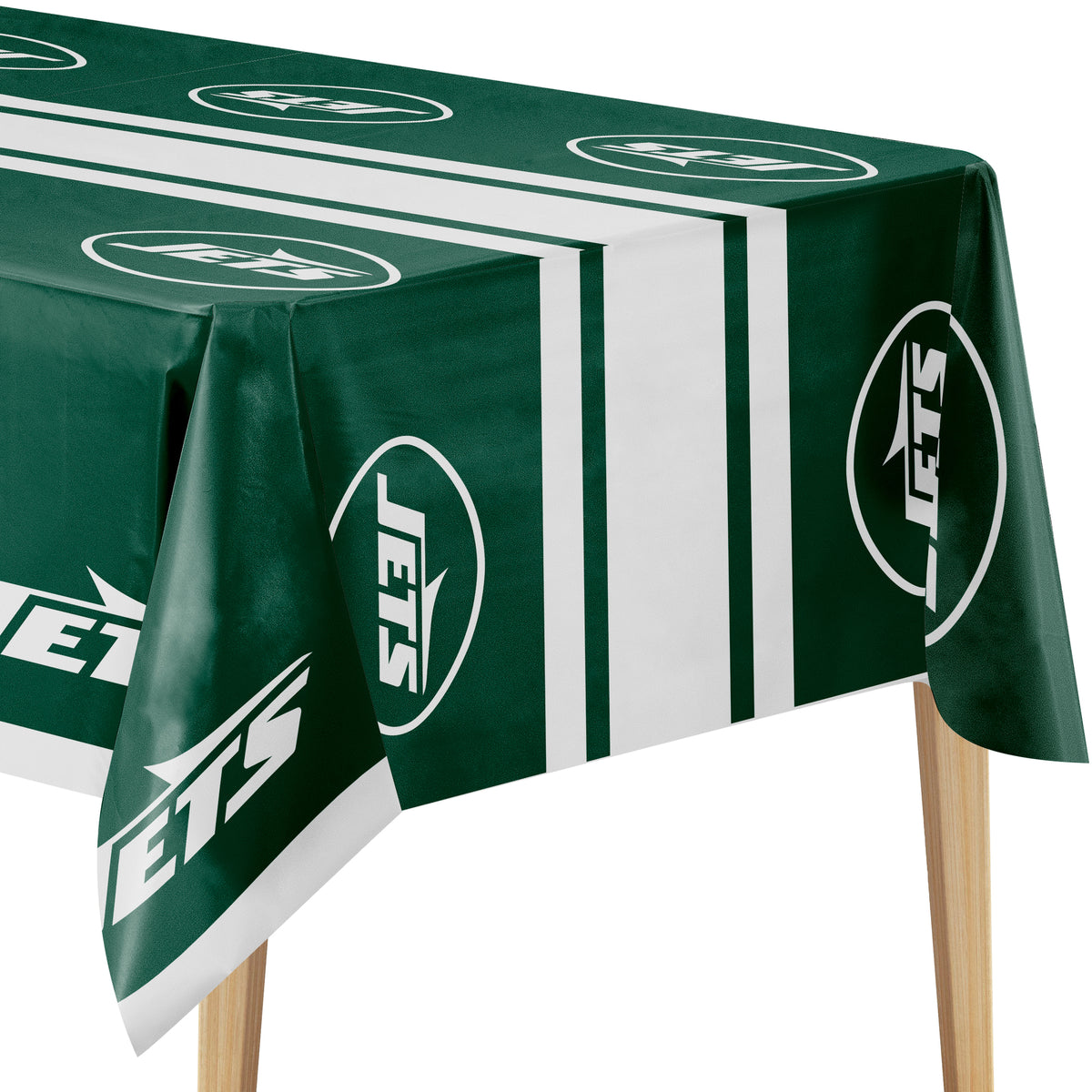 A green and white New York Jets themed tablecloth draped over a table, showing the team logo and stripes, with wooden table legs visible underneath.