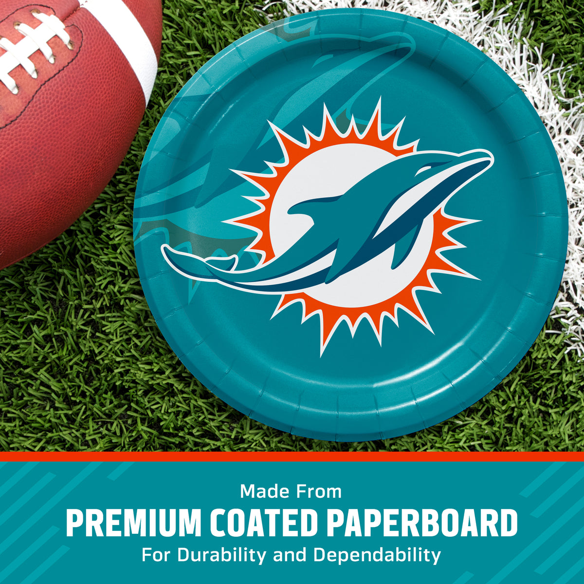A teal paper plate with the Miami Dolphins logo, shown on a grassy field with a football partially visible. A teal banner at the bottom reads 'Made From PREMIUM COATED PAPERBOARD For Durability and Dependability'.