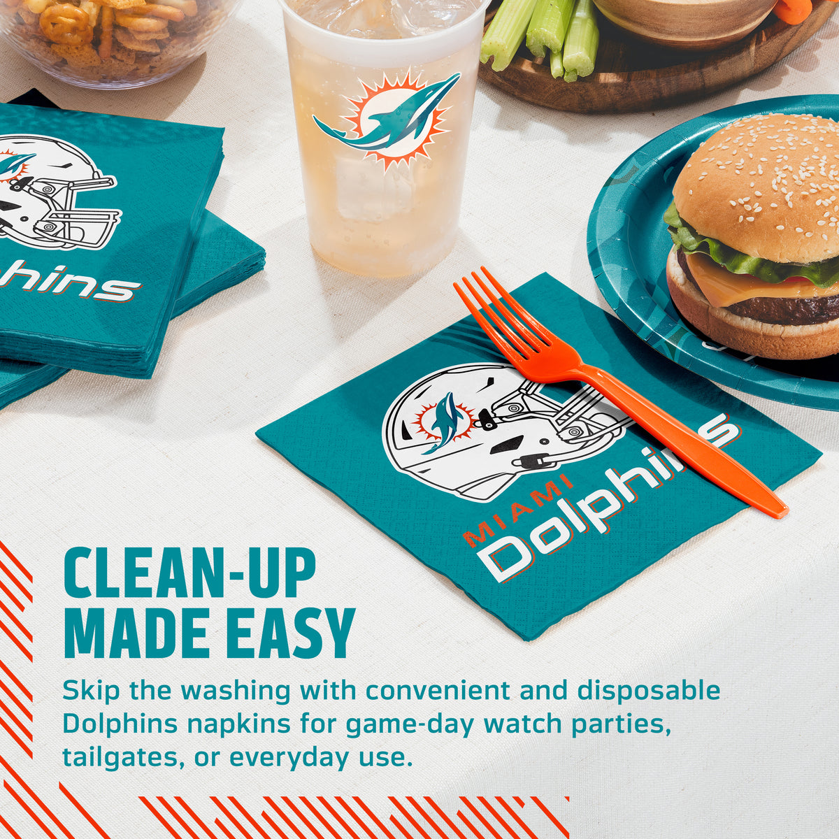 Teal Dolphins branded napkins, a matching cup, and an orange fork arranged on a table with a burger, celery, and fries. Text on the image reads 'CLEAN-UP MADE EASY' and describes disposable Dolphins napkins for game-day watch parties, tailgates, or everyday use.
