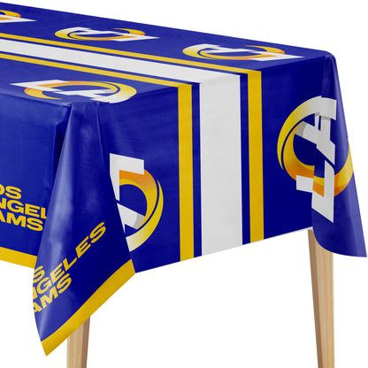 A Los Angeles Rams themed tablecloth in royal blue, white, and yellow, draped over a table with wooden legs visible against a white background.