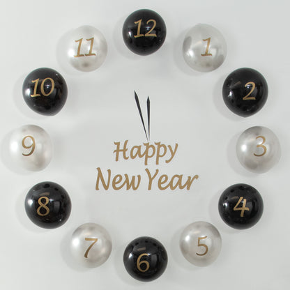 Decorative countdown clock with numbered black and silver balloons spelling 'Happy New Year' on a light background