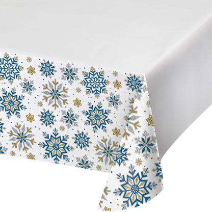 Paper tablecloth with blue, gold and silver snowflake pattern on a white background