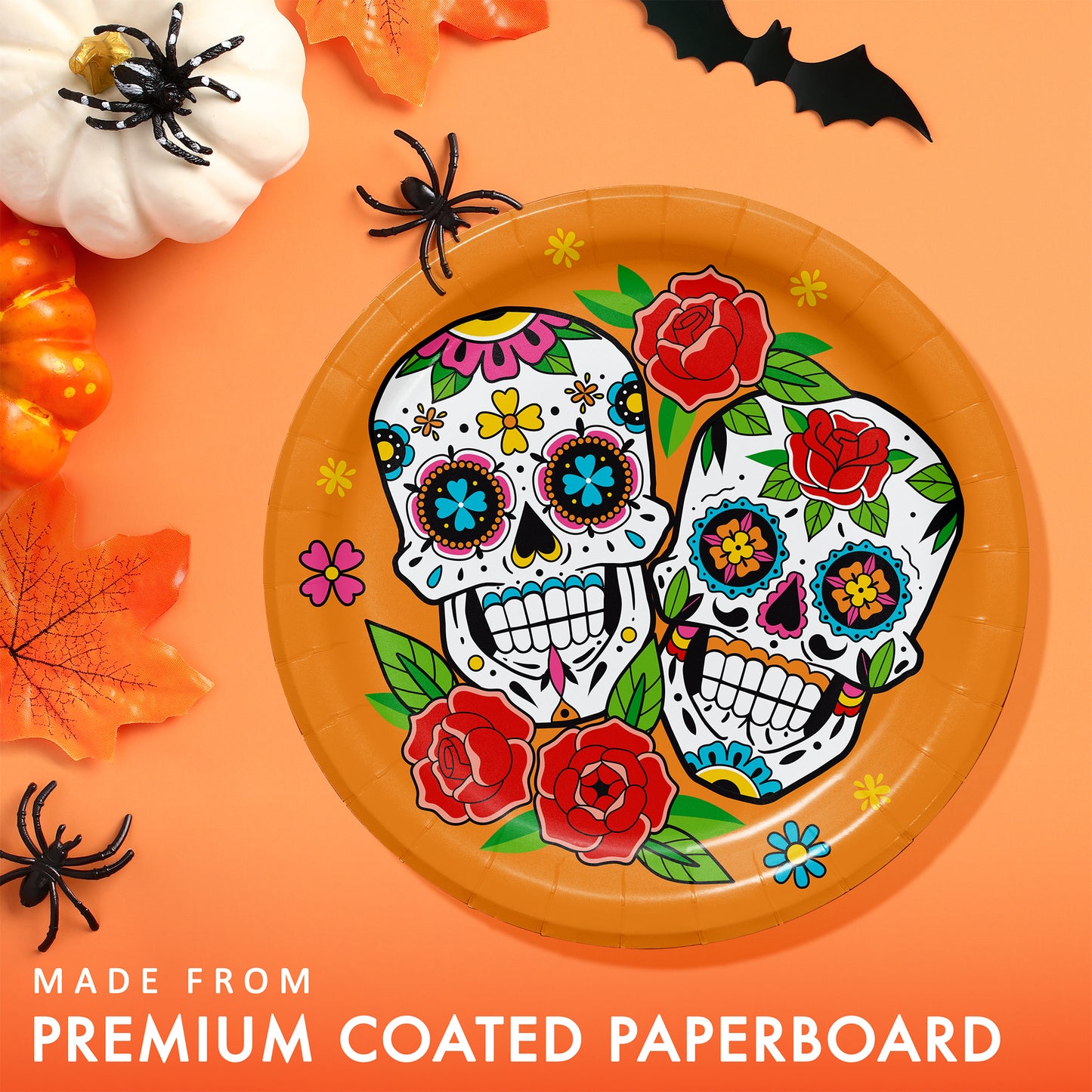 Skelebration Dessert Paper Plates 96 ct. Decorative paper plate with colorful skull design on an orange background with Halloween decorations.