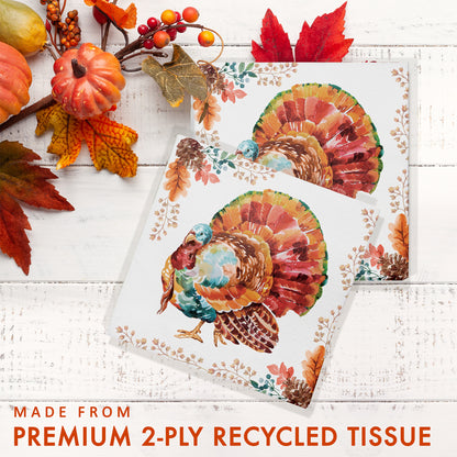 Tasteful Turkey Luncheon Napkins 192 ct. Turkey-themed tissue paper with autumn leaves and pumpkins on a white wooden background.