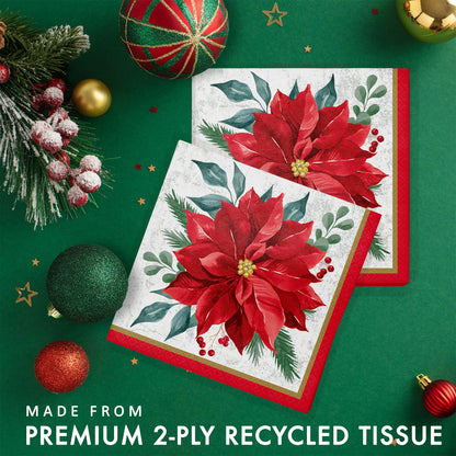 Festive Floral Luncheon Napkins 192 ct. 
Two Christmas-themed paper napkins with poinsettia design on a green background with festive decorations.