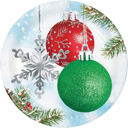 Decorative paper plate with Christmas ornaments, snowflake, and pine branches on a snowy background.