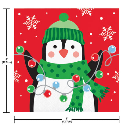Christmas Cheer Beverage Napkins 192 ct. Paper napkin featuring a penguin wearing a green hat and scarf with Christmas lights on a red background with snowflakes