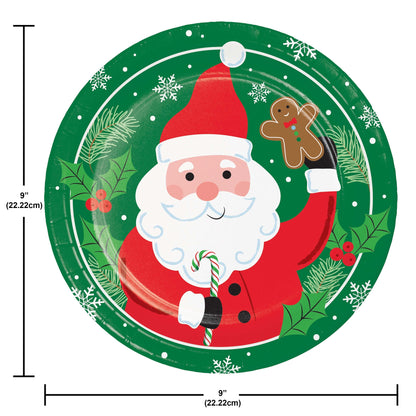 Round Christmas-themed plate with Santa Claus holding a candy cane and gingerbread man, surrounded by greenery and snowflakes. Measurements included