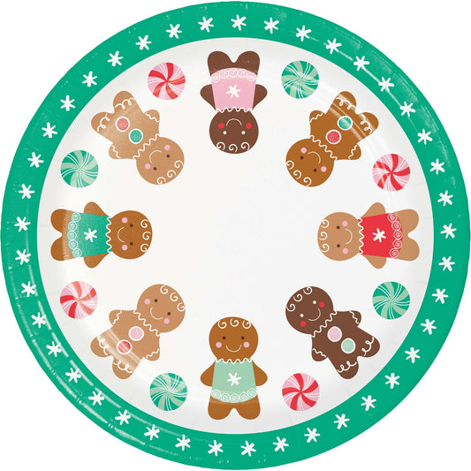 Round paper plate with gingerbread design and candy decorations with a teal rim on a white background