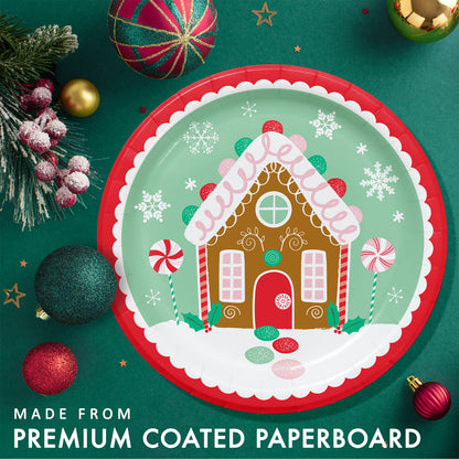 Christmas-themed paper plate with gingerbread house design. Plate shown on a green background with festive ornaments and greenery.