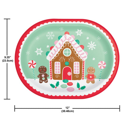 Oval decorative paper plate with a gingerbread house design and gingerbread men on a white background. Measurements shown.