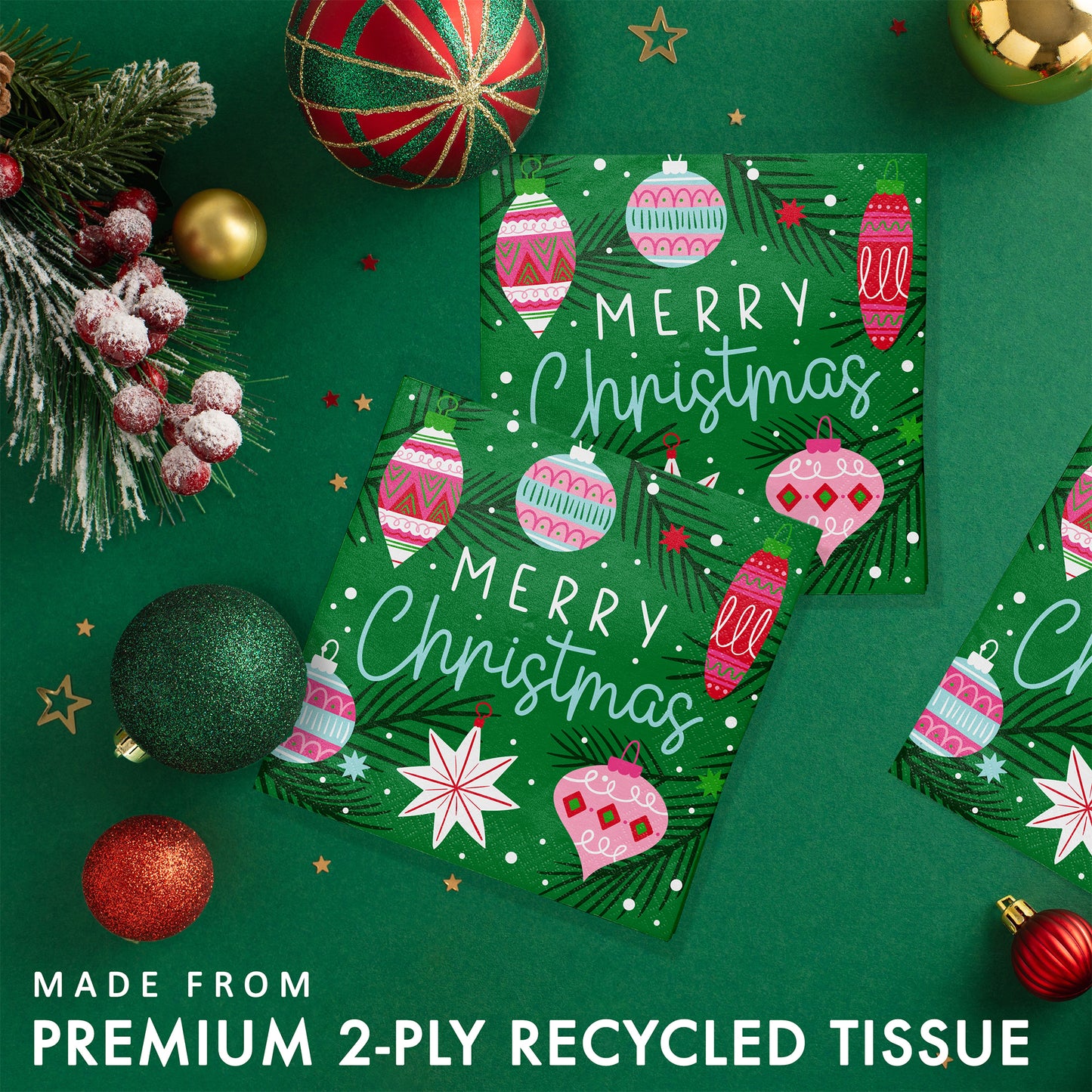Holiday Frills Merry Christmas Beverage Napkins 192 ct. Two green Christmas-themed paper napkins with ornaments on a green background with festive decorations.