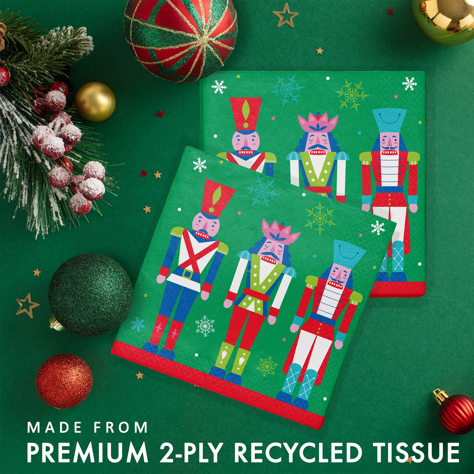 Joyful and Jolly Luncheon Napkins 192 ct. Paper napkins with three colorful nutcrackers on a green background with snowflakes