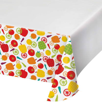Colorful tablecloth featuring various vegetables on a white background