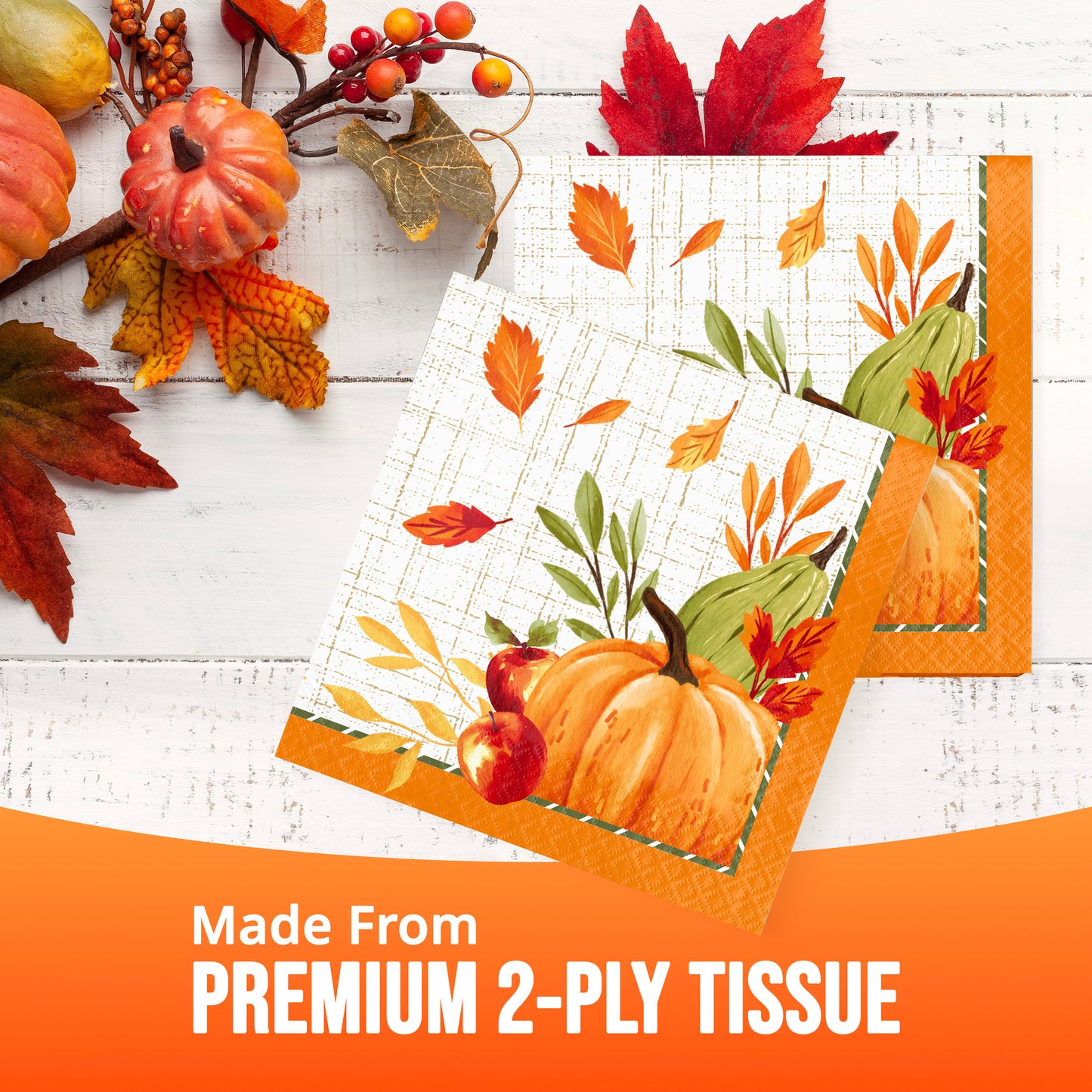Two autumn-themed tissue papers with printed pumpkins, leaves, and acorns on a white wood background. Banner at the bottom reads 'Made From PREMIUM 2-PLY TISSUE'.