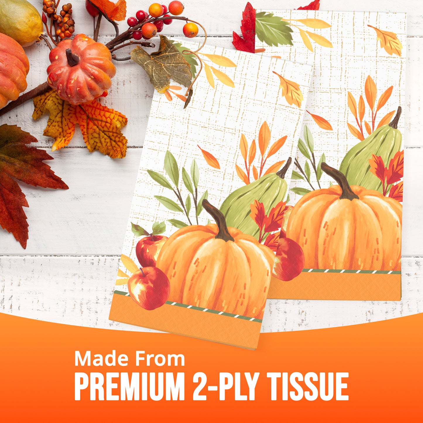 Tissue paper napkins with an autumn pumpkin and leaf print are displayed on a white wood surface. An orange banner at the bottom reads 'Made From PREMIUM 2-PLY TISSUE'.