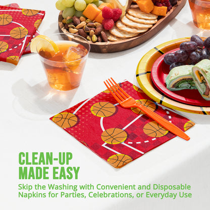 Disposable party supplies including plates, napkins, and cutlery with food on a table.