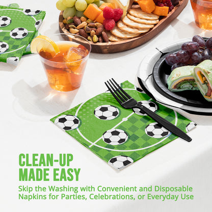 Disposable napkins with soccer ball design on a table with food and drinks.