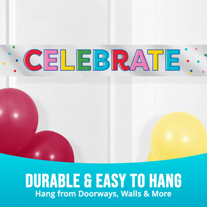 Colorful banner with "CELEBRATE" text and confetti against a white wall with balloons.