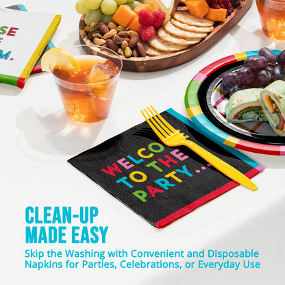 Disposable napkins with colorful text 'Welcome to the Party' on a table setting with food and drinks.