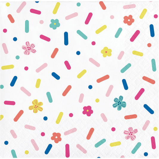 Napkin with colorful sprinkles and flowers on a white background