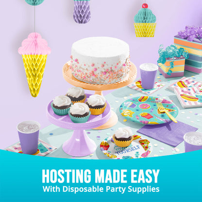 Disposable party supplies including a cake, cupcakes, plates, and cups on a table with a colorful background.