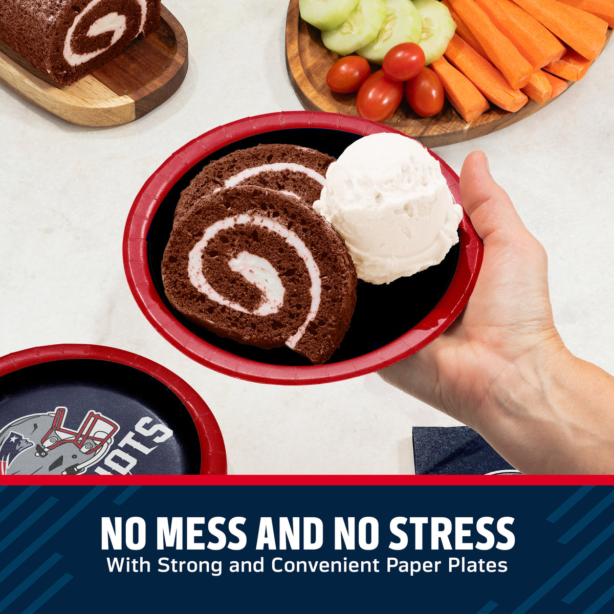 A hand holds a red paper plate with a dark chocolate cake roll and a scoop of vanilla ice cream, with sliced cake, cucumbers, tomatoes, and carrots arranged on wooden boards in the background. A dark blue banner at the bottom reads, 'NO MESS AND NO STRESS With Strong and Convenient Paper Plates.