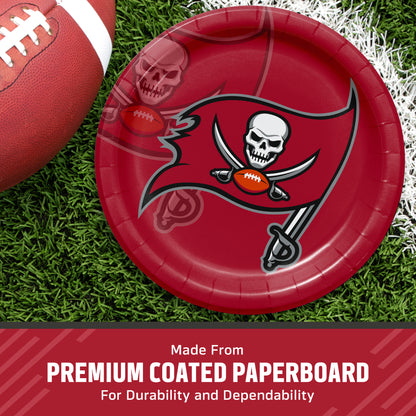 A red Tampa Bay Buccaneers themed paper plate on a green grass background next to a football, with a banner at the bottom reading 'Made From PREMIUM COATED PAPERBOARD For Durability and Dependability'.