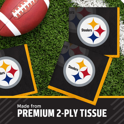 Three Pittsburgh Steelers branded square tissue napkins arranged on green turf next to a football, with text at the bottom reading 'Made from PREMIUM 2-PLY TISSUE'.