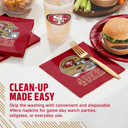 San Francisco 49ers themed red napkins with a football helmet graphic and '49ERS' text, shown on a table setting with a matching cup, plate, fork, and burger. Text on the image reads 'CLEAN-UP MADE EASY' and describes disposable 49ers napkins for game-day watch parties, tailgates, or everyday use.
