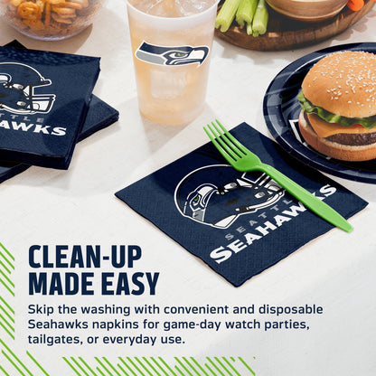 Seattle Seahawks team-themed disposable napkins shown on a tabletop with a burger, drink, green fork, and fries. Text on the image reads 'CLEAN-UP MADE EASY' and describes the convenient Seahawks napkins for game-day watch parties, tailgates, or everyday use.