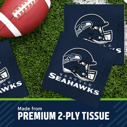 Seattle Seahawks themed 2-ply paper napkins on a green turf background with a football prop, featuring the Seahawks helmet logo and team name, with a text banner at the bottom reading 'Made from PREMIUM 2-PLY TISSUE'.