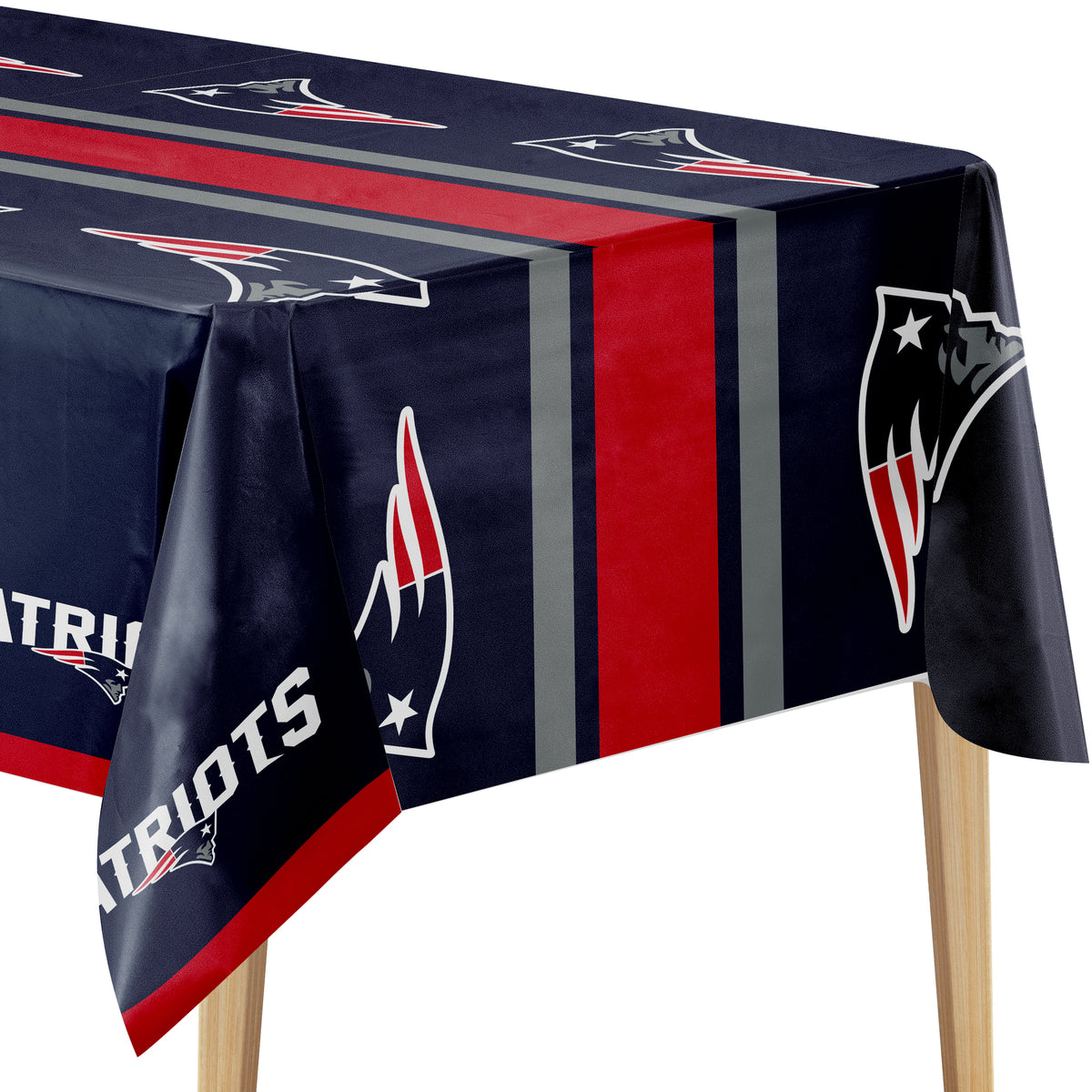 A rectangular table covered with a navy blue tablecloth featuring the New England Patriots logo, team colors, and team name. The tablecloth has vertical red and gray stripes and is shown draped over a table with wooden legs against a white background.