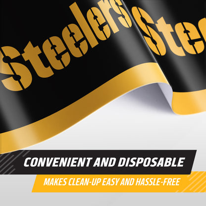 A close-up of a Steelers-branded disposable tablecloth, shown curled to reveal its design. The product is black with a bold gold Steelers logo and a gold curved stripe, with text overlays reading 'CONVENIENT AND DISPOSABLE' and 'MAKES CLEAN-UP EASY AND HASSLE-FREE'.