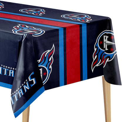 A Tennessee Titans themed tablecloth draped over a table, featuring the team logo, team name, and vertical red and blue stripes on a dark navy background.
