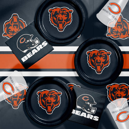 Collection of Chicago Bears-themed items including paper plates, napkins and cups on a dark background.