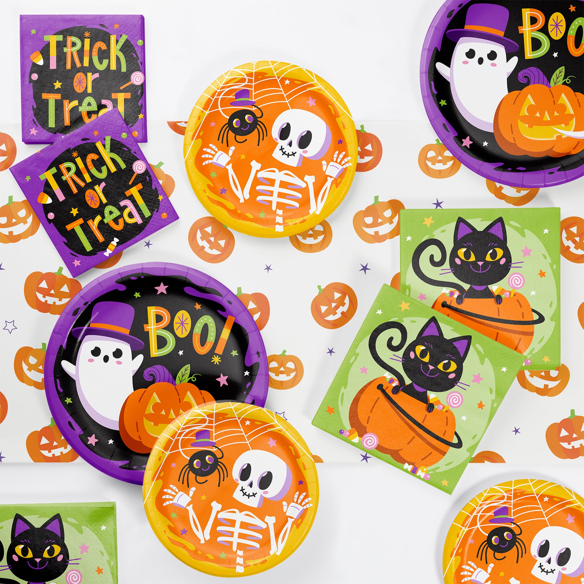 Glowing Ghouls Dessert Paper Plates 96 ct. Halloween-themed paper plates and napkins with ghost, skeleton, and cat designs on a white background.