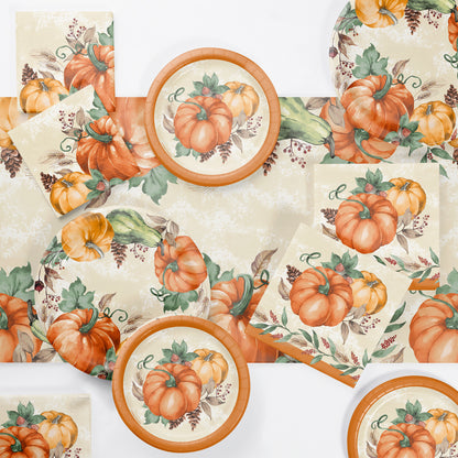 Harvest Delight Paper Tablecloths 12 ct. Table setting with pumpkin-themed plates, napkins, and tablecloth on a white background