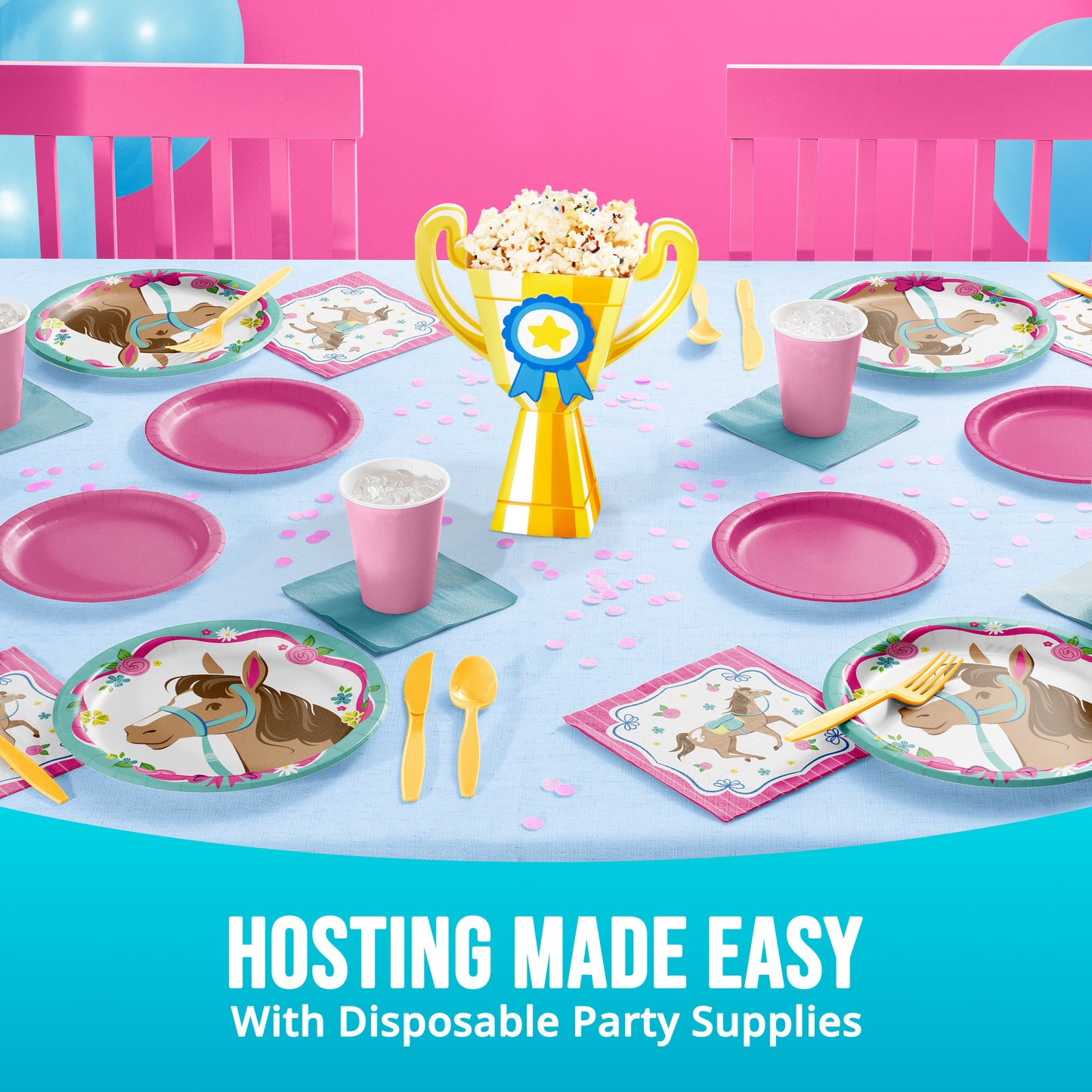 Disposable party supplies including plates, cups, and a trophy centerpiece on a table with pink and blue theme.