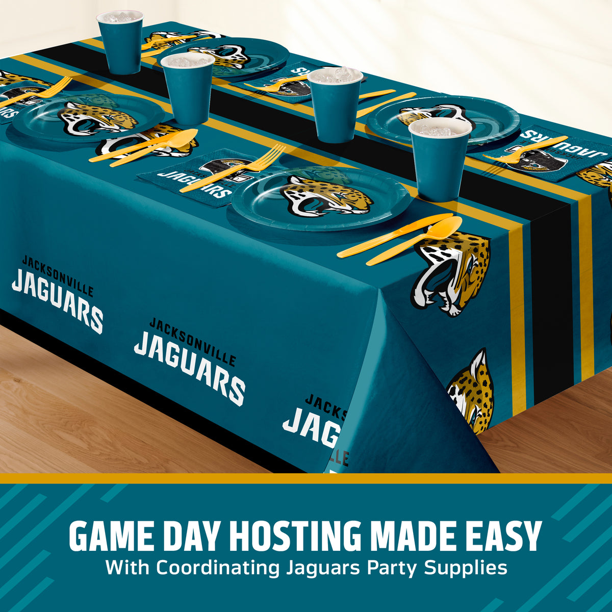 A Jacksonville Jaguars themed party table setting featuring a teal, black, and gold printed tablecloth, matching plates, cups, and utensils, displayed on a wooden floor with a promotional banner at the bottom.