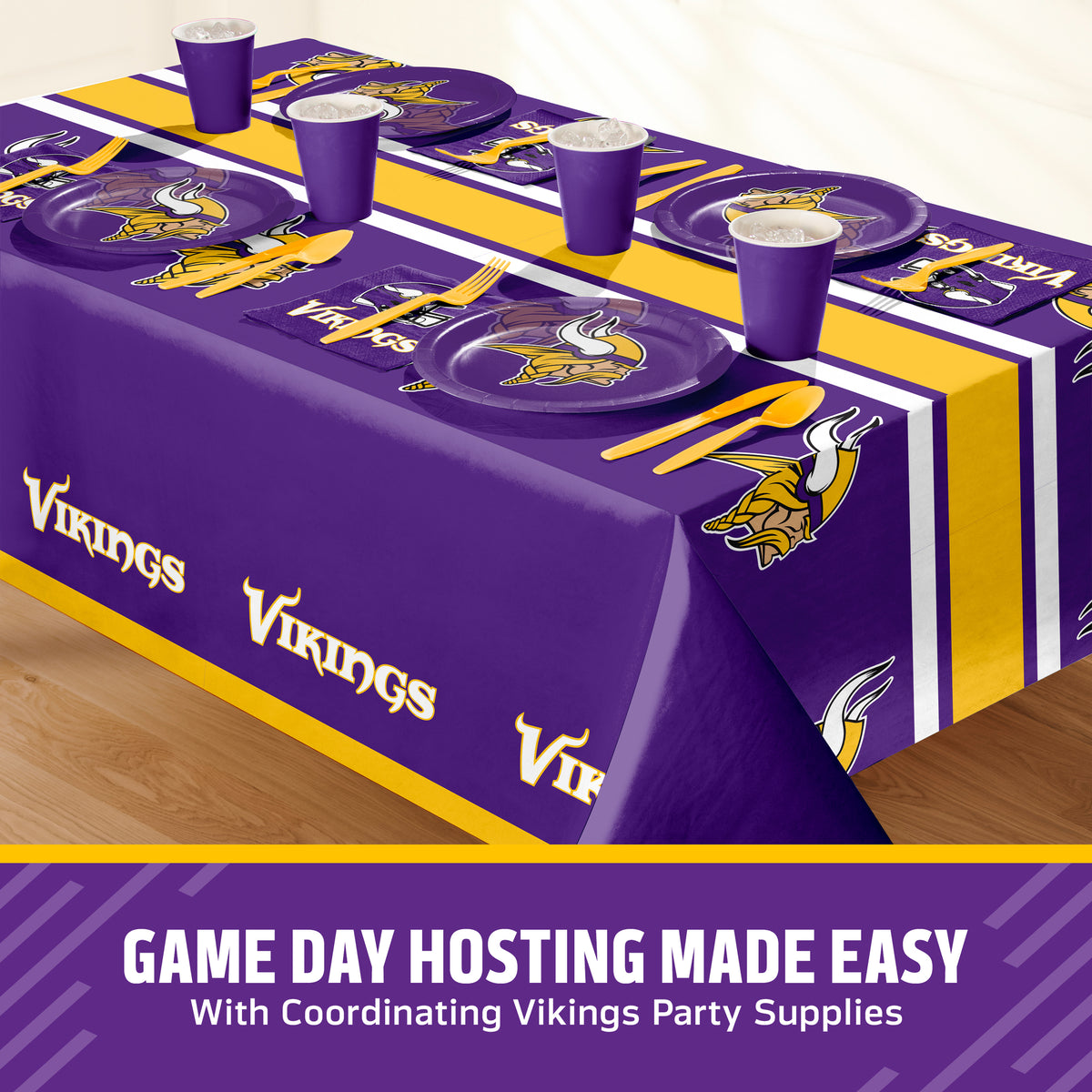 Minnesota Vikings themed party table setting with a printed tablecloth, matching plates, cups, and utensils, shown on a table with a promotional banner at the bottom that says "Game Day Hosting Made Easy".