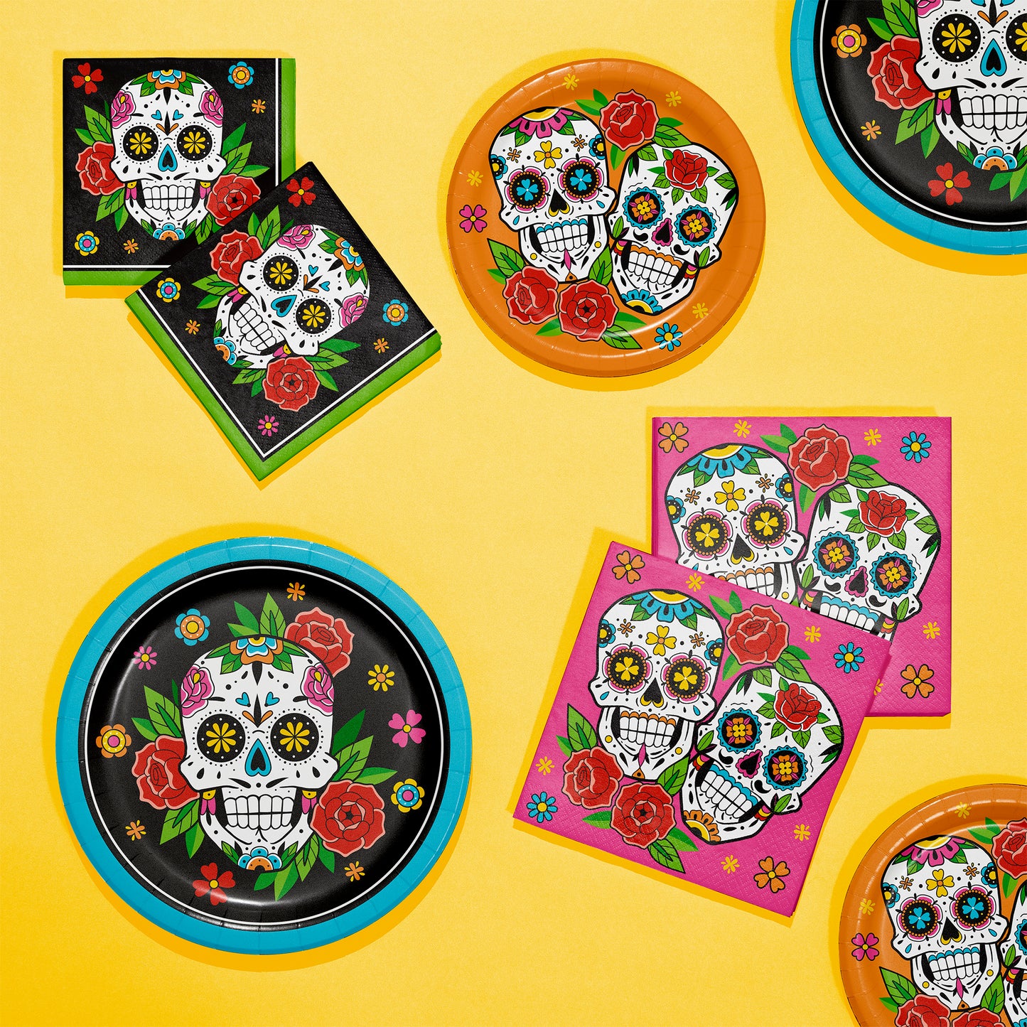 Skelebration Luncheon Napkins 192 ct.  Decorative plates and napkins with colorful skull designs on a yellow background