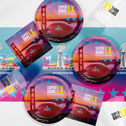 Super Bowl LX promotional graphic shown on paper napkins, paper plates, plastic cups and plastic tablecloth with a football and the Golden Gate Bridge in the background